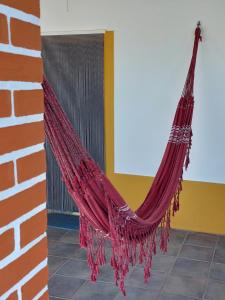 a red hammock hanging from a brick wall at Monte Santiago in Fronteira