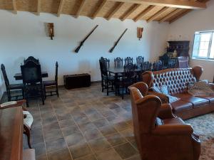 a living room with a couch and a table and chairs at Monte Santiago in Fronteira