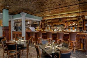 a restaurant with tables and a bar at Rockport Harbor Hotel in Rockport