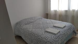 a bed with two pillows on it in a bedroom at Nehuen APartB in Neuquén