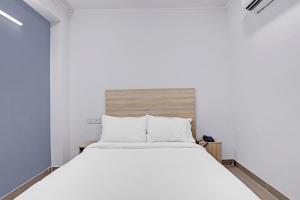 a bedroom with a large white bed in a room at Hotel Grand Capitol-2 in Jaipur