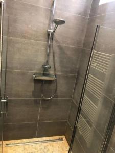 a shower with a shower head in a bathroom at Unique Space for great stays in Brussels