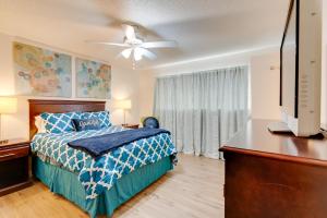 a bedroom with a bed and a ceiling fan at Breezy Fresno Home - Near Airport and Downtown in Fresno