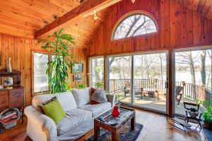 a living room with a couch and some windows at Pet-Friendly Cabin Overlooking Sleepy Hollow Lake in Athens