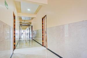 a hallway of a building with glass doors at OYO Flagship 84218 Hotel Bankar House in Sonai
