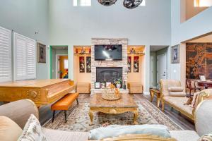 a living room with a piano and a fireplace at North Las Vegas Home about 9 Mi to the Strip! in Las Vegas