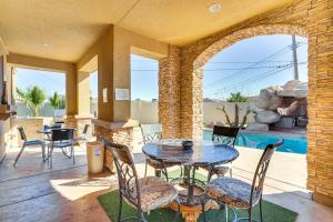 a patio with a table and chairs and a pool at North Las Vegas Home about 9 Mi to the Strip! in Las Vegas