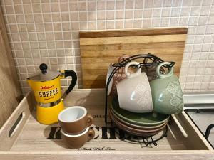 a tray with tea pots and cups on a counter at Casa Monopoli in Monopoli