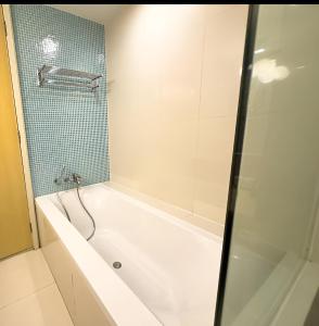 a bathroom with a bath tub and a shower at KLCC Cormar Premium Suites at Kuala Lumpur City Center in Kuala Lumpur