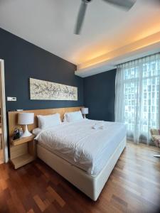 a bedroom with a large bed and a large window at KLCC Cormar Premium Suites at Kuala Lumpur City Center in Kuala Lumpur