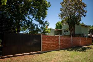 a fence in front of a house at Eleven in Posadas