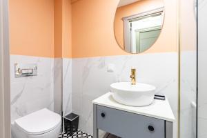 a bathroom with a sink and a mirror at Kiztasi Apartments-Orange and Blue in Istanbul