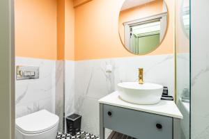 a bathroom with a sink and a mirror at Kiztasi Apartments-Orange and Blue in Istanbul