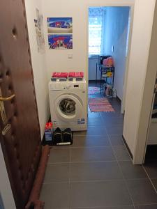 a laundry room with a washing machine in a hallway at City Apartment in Salzburg