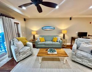 a living room with two couches and a coffee table at Salty Shenanigans in Kill Devil Hills