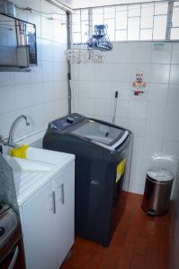 a small kitchen with a trash can and a trash can at Apto moderno en norte de Bogotá in Bogotá