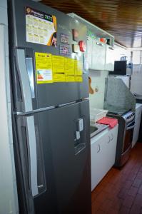 a kitchen with a refrigerator with notices on it at Apto moderno en norte de Bogotá in Bogotá