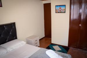 a bedroom with a bed with a black headboard at Apto moderno en norte de Bogotá in Bogotá