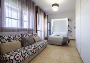 a living room with a couch and a bed at Bologna Fair Expo Apartment in Bologna