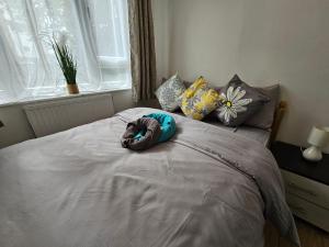 a bed with a pillow on top of it at Globe Rooms in London