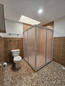 a bathroom with a shower with a toilet in it at Sensity Home Recamara moderna in Tehuacán