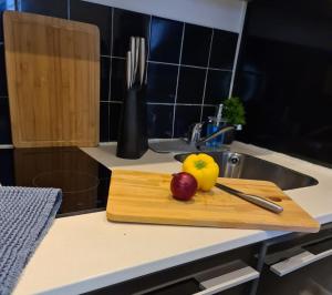 a cutting board with fruit on a kitchen counter at City Skyline View Studio Apartment - Birmingham Central in Birmingham
