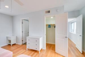 a bedroom with white walls and a bed and a closet at Boardwalk to Beach Ocean-View Surfside Home! in Surfside Beach +35 photos