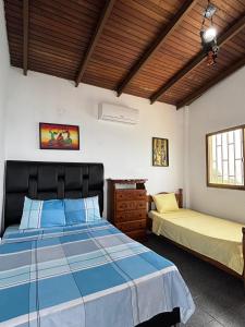a bedroom with two beds and a wooden ceiling at Mochima Inn 