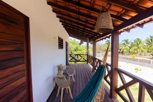 a hammock on the porch of a house at Casa com piscina na tranquilidade de Barra Grande in Barra Grande