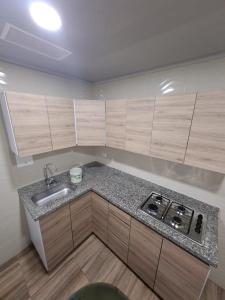 a kitchen with a sink and a stove in it at Casa Hotel Mónaco in Bogotá