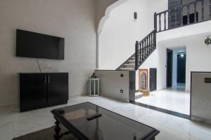 een woonkamer met een tv en een salontafel bij RIAD TAWSALANE in Marrakesh