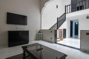 a living room with a tv and a coffee table at RIAD TAWSALANE in Marrakesh
