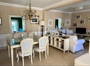 a living room with a dining table and a couch at Herdade de Santa Maria in Almeirim