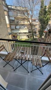 a balcony with two wooden chairs and a window at breath studio in Giannitsa