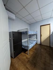 a room with two bunk beds and a door at Acho Rancho in Murcia