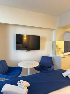 a room with a bed and a table and a tv at Sea views apartments In Batumi in Batumi