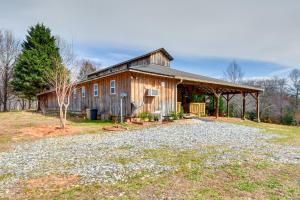 a barn with a gravel driveway in front of it at Converted Barn Couple's Oasis Near Tallulah Gorge in Clarkesville