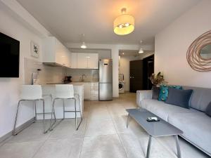 a living room with a couch and a kitchen at P&P - Brand new chic apartments in Athens