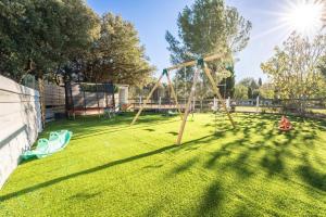 a park with a swing set in the grass at DOMAINE DE LA SOURCO - Villa, Maisons & Chalet, Magnifique Havre De Paix En Provence in Trans-en-Provence