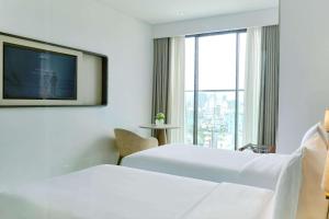 A bed or beds in a room at Radisson Hotel Danang