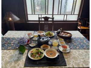 a table with plates of food on a table at Ukishimakan Bettei Guest House - Vacation STAY 14350 in Shimo-rokka