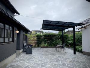 a patio with a table and chairs under awning at Ukishimakan Bettei Guest House - Vacation STAY 14350 in Shimo-rokka
