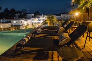 a table on a balcony next to a swimming pool at Casa Continental Hotel Boutique & Suites - Adults Only in Mérida
