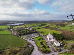 an aerial view of a white church in a green field at Ocean View in Glandore