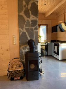 a stove in a kitchen with a stone wall at Mountain View Chalet with HotTub and Sauna in Czerwienne