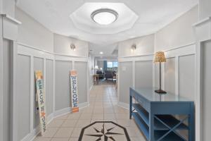 a hallway with a blue desk and a tile floor at Yacht Club Villas #2-504 condo in Myrtle Beach