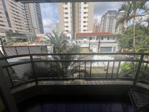 a balcony with a view of a city at Suíte completa no Bueno Somente para mulheres in Goiânia