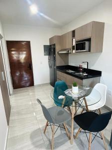 a small kitchen with a table and chairs in a room at Loft Marina Cerritos in Mazatlán
