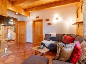 a living room with a couch and a table at Chalet Emely in Piesendorf