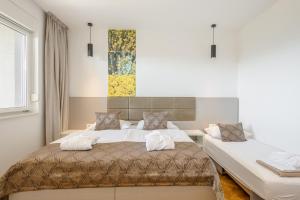 a bedroom with two beds and a window at Rogač Rooms & Restaurant in Omiš